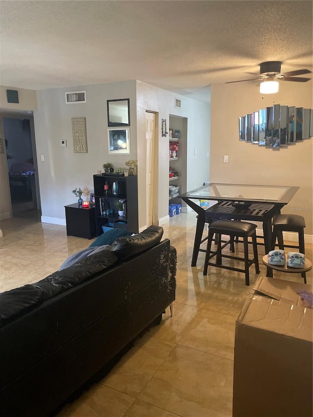 203 Pine Violet Ct Unit 202, Tampa, FL 33612 - living room featuring a textured ceiling and ceiling fan