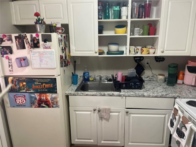 203 Pine Violet Ct Unit 202, Tampa, FL 33612 - kitchen with white appliances, white cabinetry, and open shelves