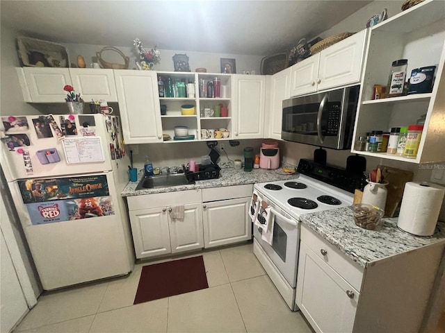 203 Pine Violet Ct Unit 202, Tampa, FL 33612 - kitchen with white appliances, open shelves, light tile patterned floors, and white cabinetry