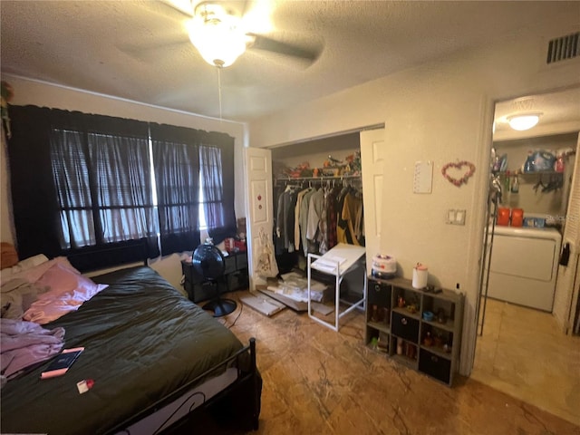 203 Pine Violet Ct Unit 202, Tampa, FL 33612 - bedroom featuring washer / clothes dryer, a closet, a textured ceiling, and ceiling fan