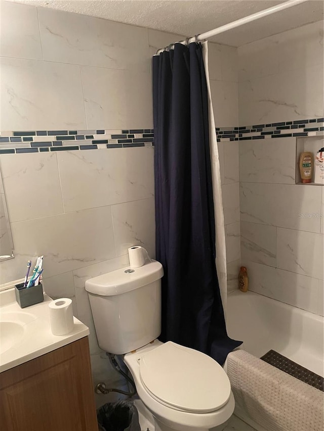 203 Pine Violet Ct Unit 202, Tampa, FL 33612 - bathroom with vanity, shower / bath combination with curtain, tile walls, and a textured ceiling