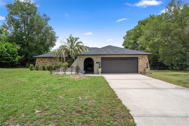 1376 Fayetteville Dr, Spring Hill, FL 34609 - ranch-style home with a garage, driveway, a front yard, stone siding, and stucco siding
