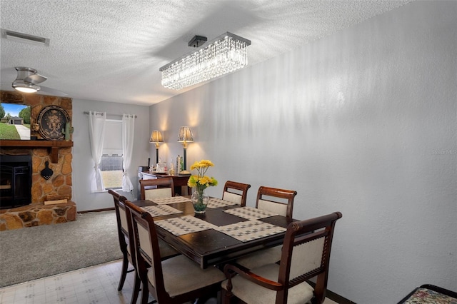 1376 Fayetteville Dr, Spring Hill, FL 34609 - dining room featuring a textured ceiling, light carpet, a fireplace, and light floors