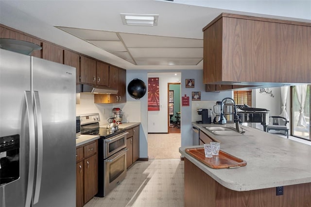 1376 Fayetteville Dr, Spring Hill, FL 34609 - kitchen with stainless steel appliances, light floors, under cabinet range hood, and light countertops