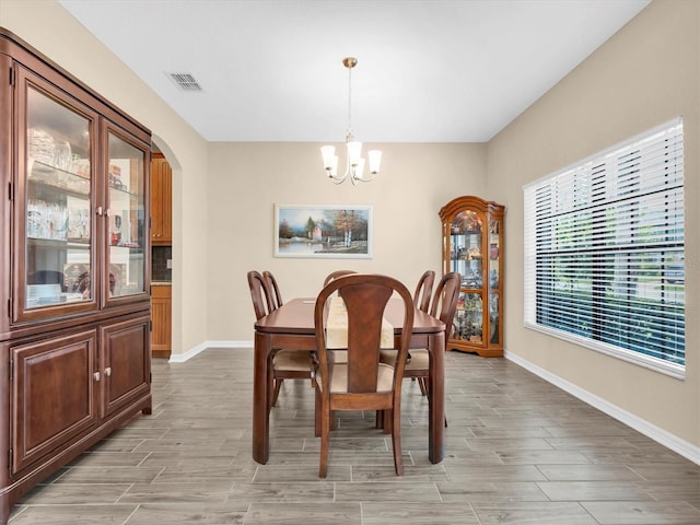 19326 Long Lake Ranch Blvd, Lutz, FL 33558 - dining space with a chandelier, light wood-type flooring, and arched walkways
