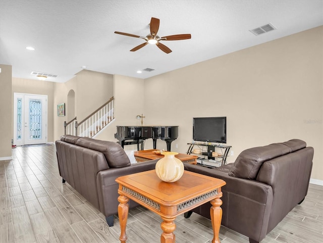 19326 Long Lake Ranch Blvd, Lutz, FL 33558 - living room featuring ceiling fan, light wood finished floors, arched walkways, stairway, and recessed lighting