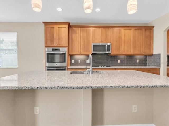 19326 Long Lake Ranch Blvd, Lutz, FL 33558 - kitchen featuring appliances with stainless steel finishes, decorative backsplash, a kitchen island with sink, and recessed lighting