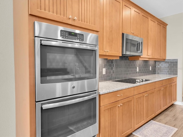 19326 Long Lake Ranch Blvd, Lutz, FL 33558 - kitchen with appliances with stainless steel finishes, decorative backsplash, light wood-style floors, and light stone countertops