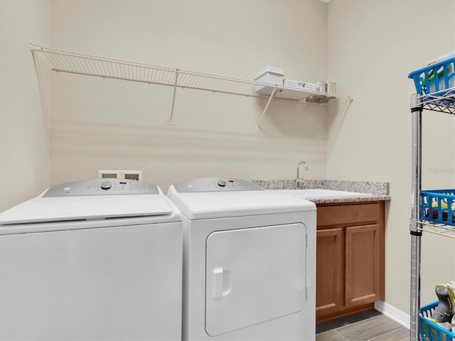 19326 Long Lake Ranch Blvd, Lutz, FL 33558 - laundry room with independent washer and dryer, light wood finished floors, and cabinet space