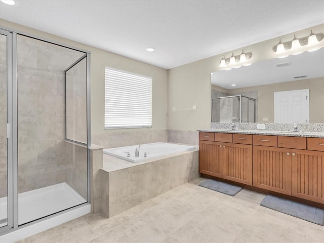 19326 Long Lake Ranch Blvd, Lutz, FL 33558 - full bathroom with double vanity, a bath, a stall shower, tile patterned flooring, and recessed lighting