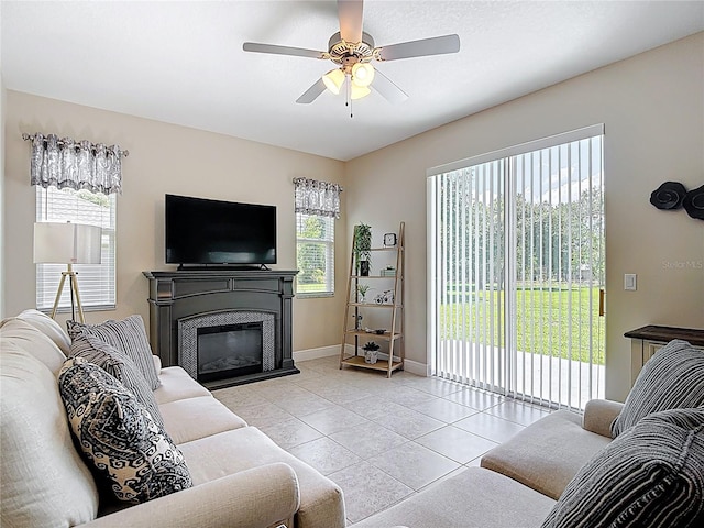 12323 House Finch, Weeki Wachee, FL 34614 - tiled living room featuring a ceiling fan and a glass covered fireplace