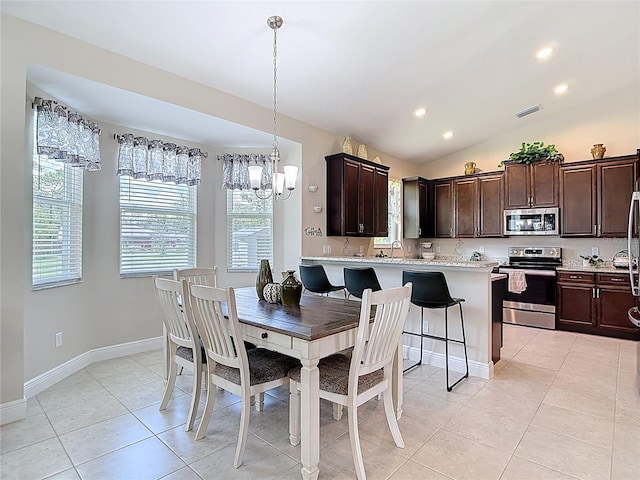 12323 House Finch, Weeki Wachee, FL 34614 - dining area featuring a chandelier, light tile patterned floors, recessed lighting, and vaulted ceiling