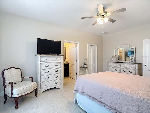 12323 House Finch, Weeki Wachee, FL 34614 - bedroom featuring light tile patterned flooring, a ceiling fan, and ensuite bath
