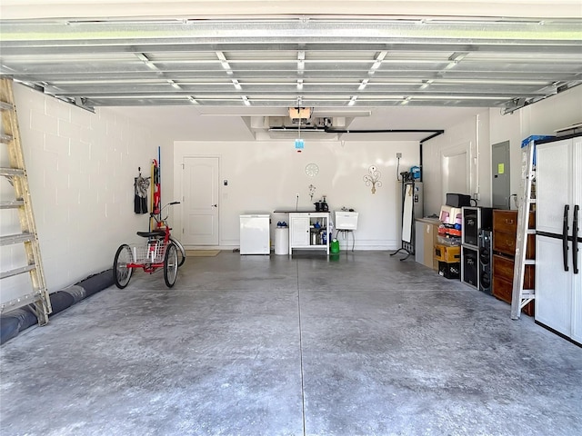 12323 House Finch, Weeki Wachee, FL 34614 - garage featuring fridge, electric panel, and a garage door opener