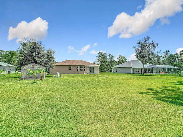 12323 House Finch, Weeki Wachee, FL 34614 - view of green lawn featuring a storage unit