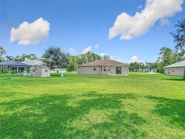 12323 House Finch, Weeki Wachee, FL 34614 - view of green lawn with a storage unit