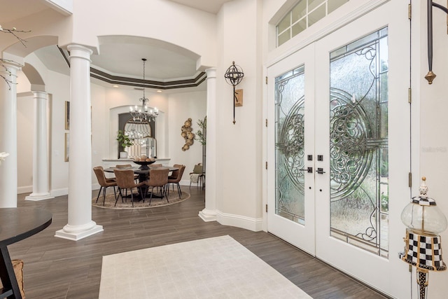 10342 Altrara Way, Trinity, FL 34655 - entryway with ornate columns, french doors, dark wood-style floors, arched walkways, and a raised ceiling