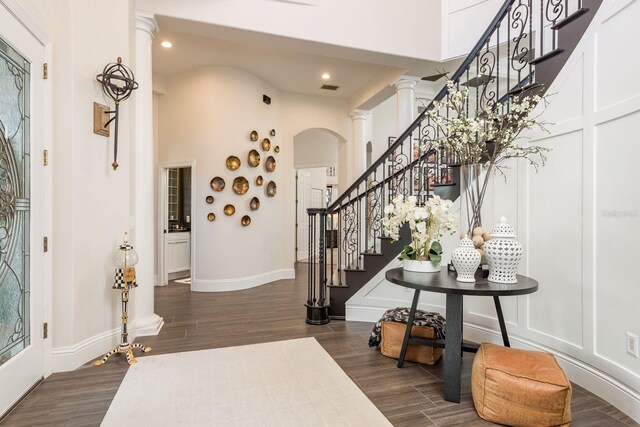 10342 Altrara Way, Trinity, FL 34655 - foyer with decorative columns, arched walkways, dark wood-style flooring, stairs, and recessed lighting