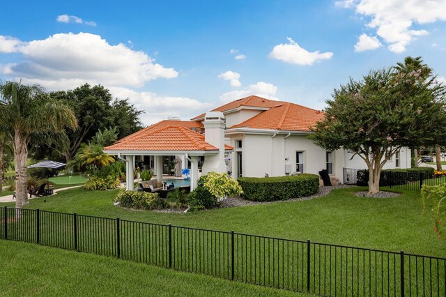 10342 Altrara Way, Trinity, FL 34655 - back of house featuring stucco siding, a tiled roof, and a fenced backyard