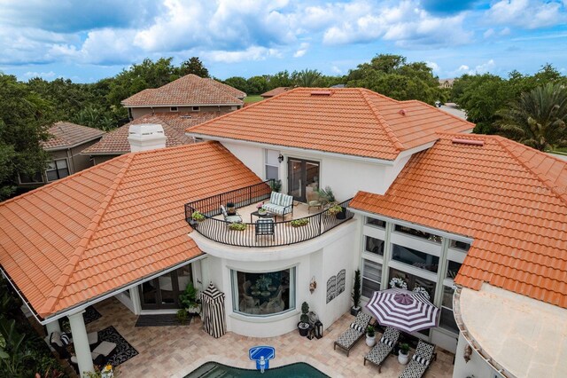 10342 Altrara Way, Trinity, FL 34655 - back of property featuring a tiled roof, stucco siding, a balcony, and a patio