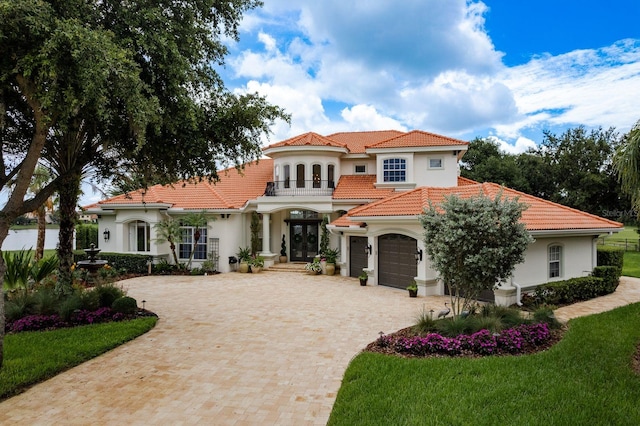 10342 Altrara Way, Trinity, FL 34655 - mediterranean / spanish-style home with french doors, decorative driveway, stucco siding, and a tiled roof