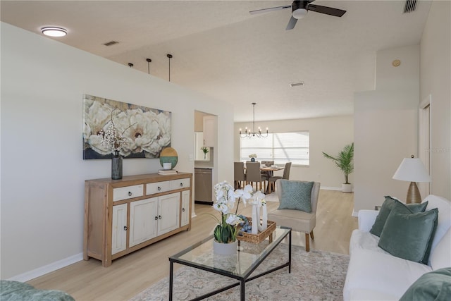 4752 Weasel Dr, New Port Richey, FL 34653 - living room featuring light wood-type flooring, a chandelier, and ceiling fan