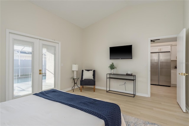 4752 Weasel Dr, New Port Richey, FL 34653 - bedroom featuring freestanding refrigerator, access to outside, lofted ceiling, light wood finished floors, and french doors