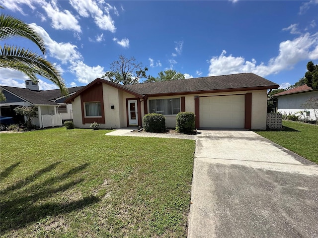 8312 Split Rail Ln, Hudson, FL 34667 - view of front of home featuring driveway, a garage, a front lawn, and stucco siding
