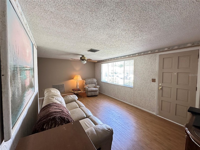 8312 Split Rail Ln, Hudson, FL 34667 - living room featuring wood finished floors, a textured ceiling, and ceiling fan