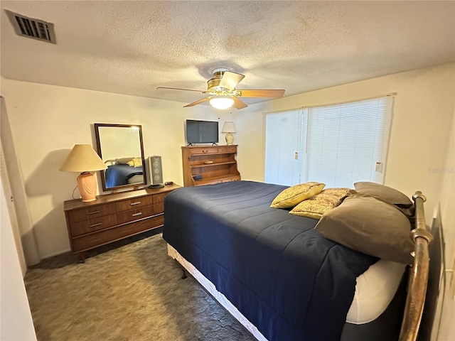 8312 Split Rail Ln, Hudson, FL 34667 - bedroom featuring dark colored carpet, a textured ceiling, and a ceiling fan