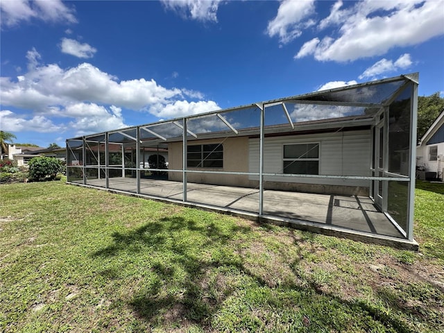 8312 Split Rail Ln, Hudson, FL 34667 - back of house featuring a lawn, a patio, and glass enclosure
