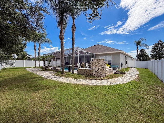 2326 Mountain Ash Way, New Port Richey, FL 34655 - rear view of house with a fenced backyard, stucco siding, a lanai, and a patio area