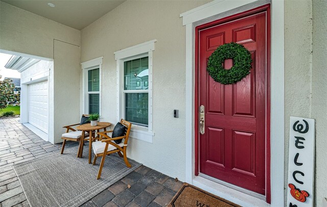 4197 Glade Wood Loop, New Port Richey, FL 34655 - property entrance with stucco siding and a porch
