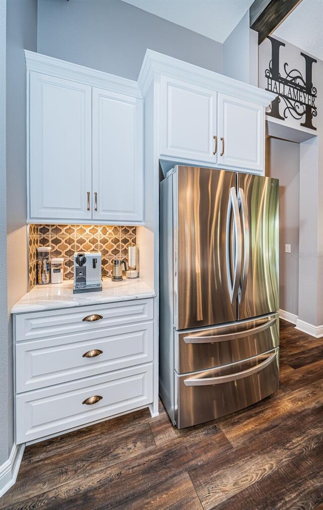 4197 Glade Wood Loop, New Port Richey, FL 34655 - kitchen featuring freestanding refrigerator, dark wood-style floors, tasteful backsplash, and white cabinets