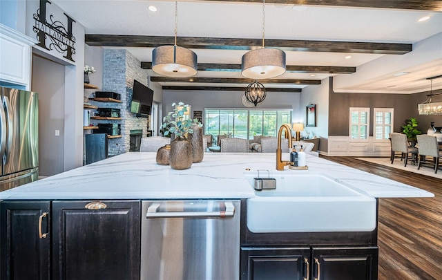 4197 Glade Wood Loop, New Port Richey, FL 34655 - kitchen with open floor plan, a center island with sink, stainless steel appliances, dark cabinetry, and dark wood-style flooring