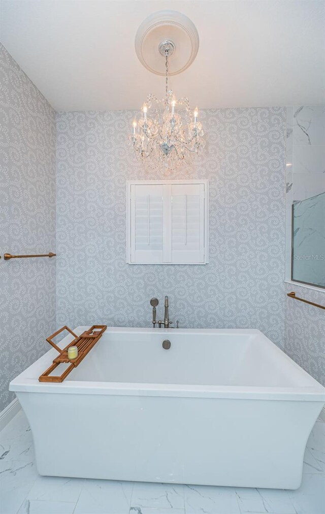 4197 Glade Wood Loop, New Port Richey, FL 34655 - full bathroom with marble finish floors, wallpapered walls, a freestanding tub, and a chandelier