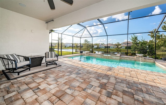 4197 Glade Wood Loop, New Port Richey, FL 34655 - view of pool featuring a patio area, a ceiling fan, a pool with connected hot tub, and a water view