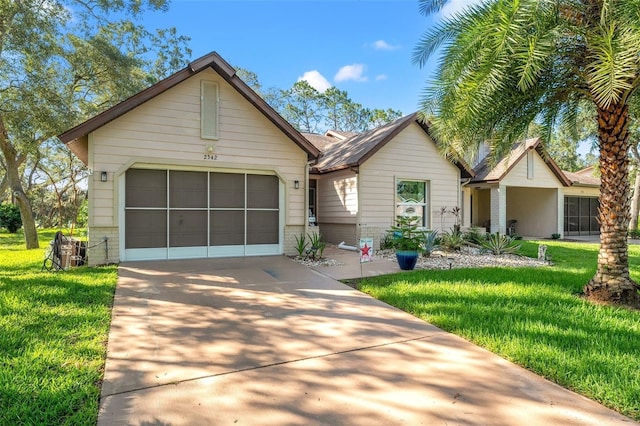 2342 Countryside Dr, Spring Hill, FL 34606 - view of front facade with concrete driveway, a front lawn, a garage, and brick siding