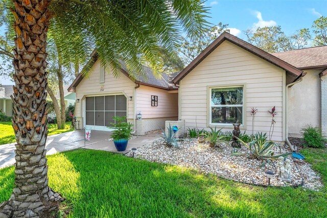 2342 Countryside Dr, Spring Hill, FL 34606 - view of front of home featuring driveway, a garage, a front yard, and roof with shingles