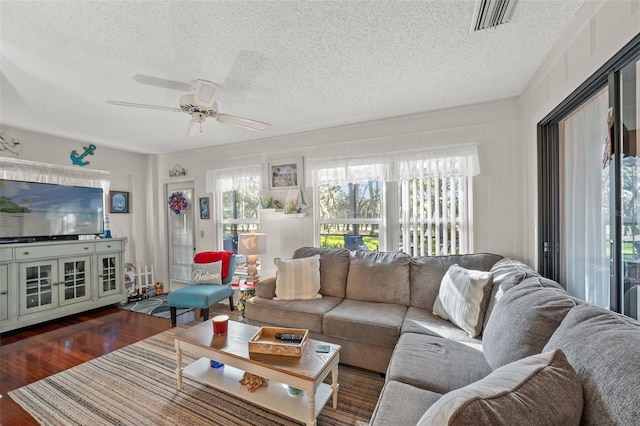 2342 Countryside Dr, Spring Hill, FL 34606 - living area featuring a textured ceiling, ceiling fan, and dark wood-style floors