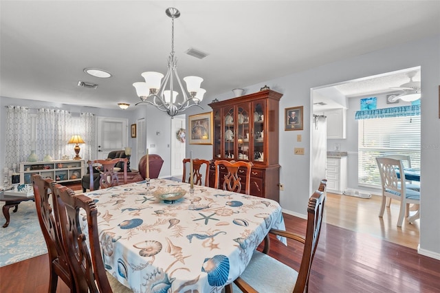 2342 Countryside Dr, Spring Hill, FL 34606 - dining area with a chandelier and wood finished floors