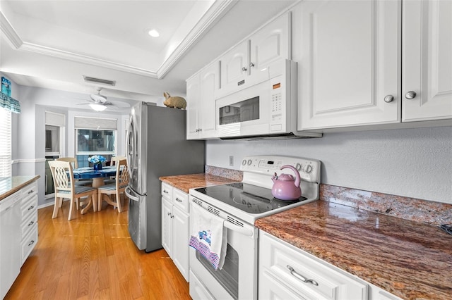 2342 Countryside Dr, Spring Hill, FL 34606 - kitchen with white appliances, white cabinetry, light wood finished floors, a tray ceiling, and ceiling fan