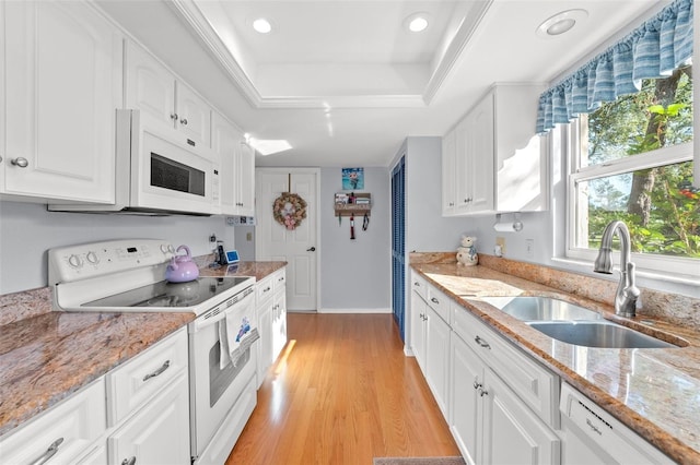 2342 Countryside Dr, Spring Hill, FL 34606 - kitchen with white appliances, a raised ceiling, white cabinets, light wood finished floors, and recessed lighting