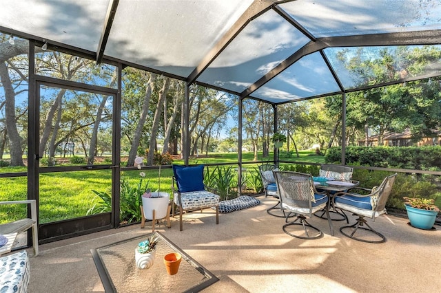 2342 Countryside Dr, Spring Hill, FL 34606 - unfurnished sunroom with outdoor dining space, view of scattered trees, and vaulted ceiling