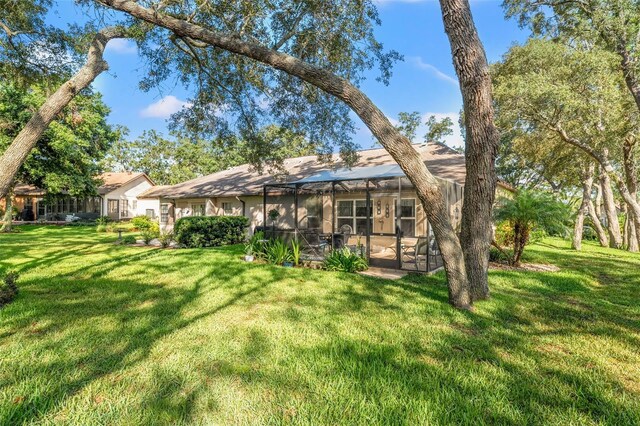 2342 Countryside Dr, Spring Hill, FL 34606 - rear view of property featuring a lawn, a lanai, and a patio