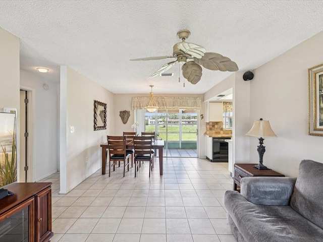 4567 Great Lakes Dr S, Clearwater, FL 33762 - dining space featuring ceiling fan, light tile patterned floors, and a textured ceiling