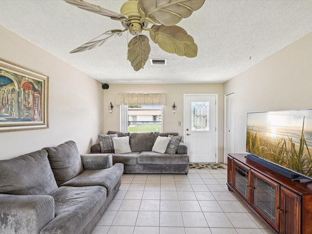 4567 Great Lakes Dr S, Clearwater, FL 33762 - living room with light tile patterned flooring, ceiling fan, and a textured ceiling