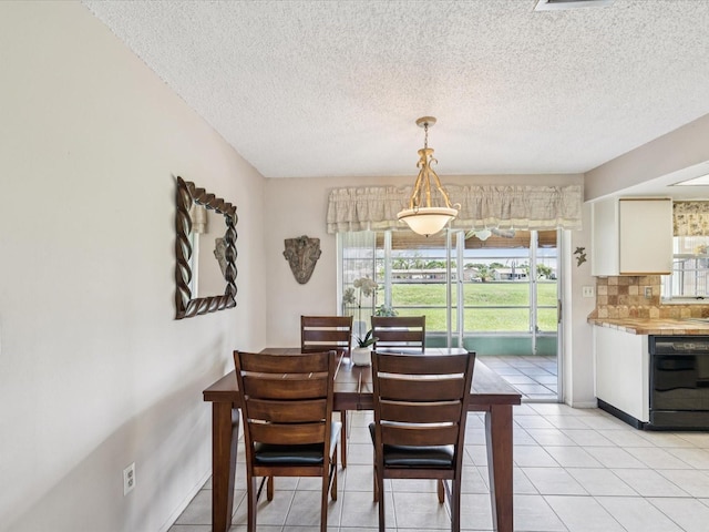 4567 Great Lakes Dr S, Clearwater, FL 33762 - dining area with a textured ceiling and light tile patterned flooring