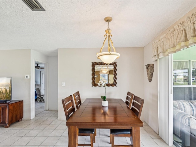 4567 Great Lakes Dr S, Clearwater, FL 33762 - dining room with light tile patterned flooring and a textured ceiling