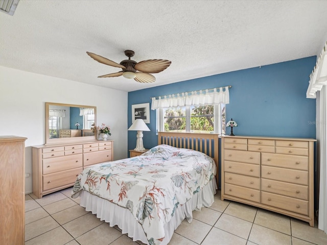 4567 Great Lakes Dr S, Clearwater, FL 33762 - bedroom with light tile patterned floors, a textured ceiling, and a ceiling fan